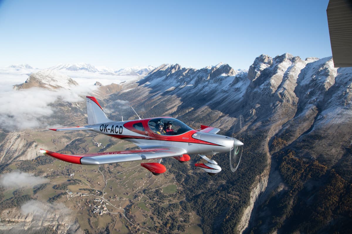 Bristell B23 over a deep alpine valley