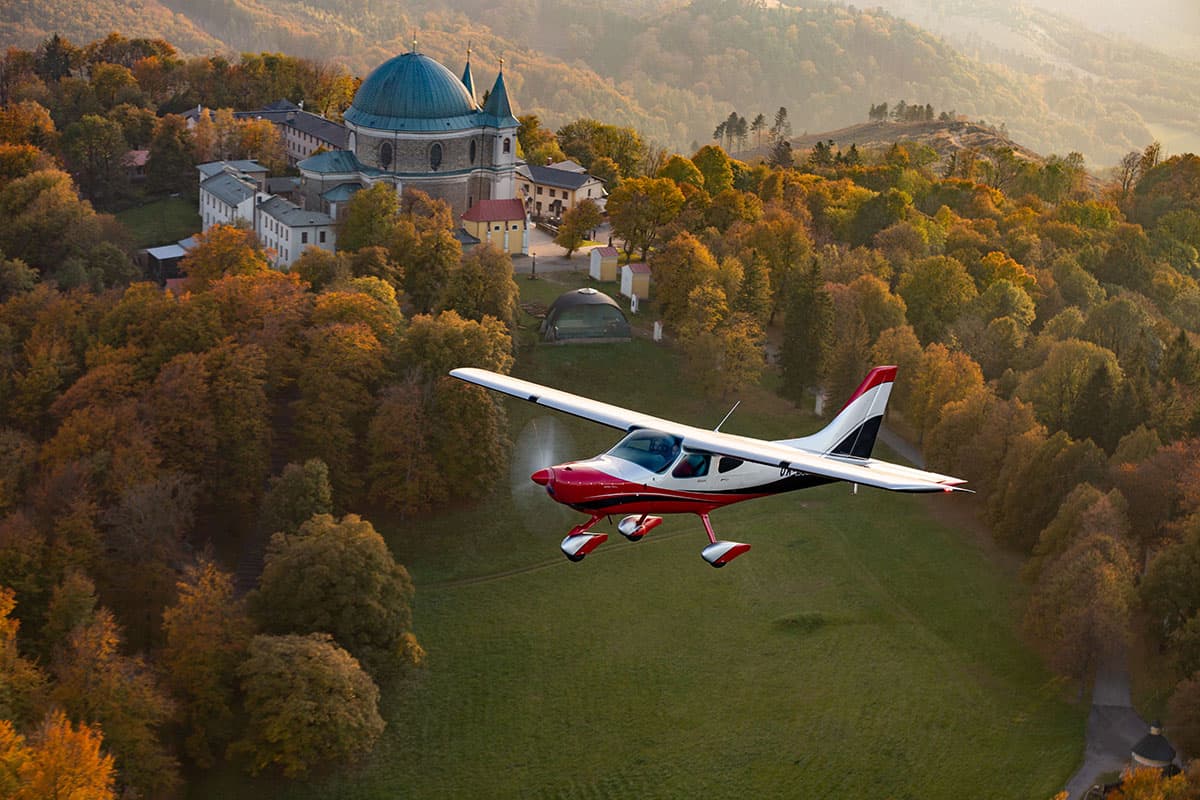 Bristell B8M cantilever high wing in flight over an autumn landscape
