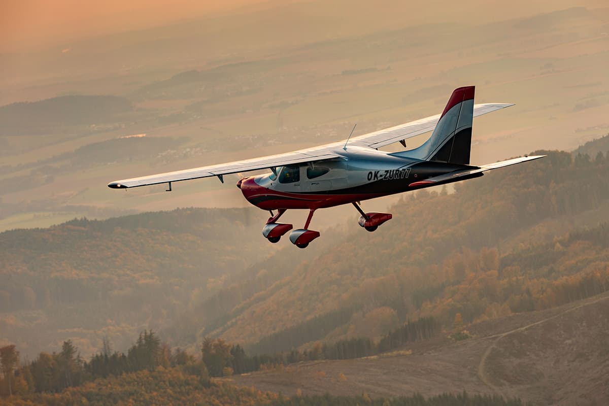 Bristell B8M in flight over autumn hills