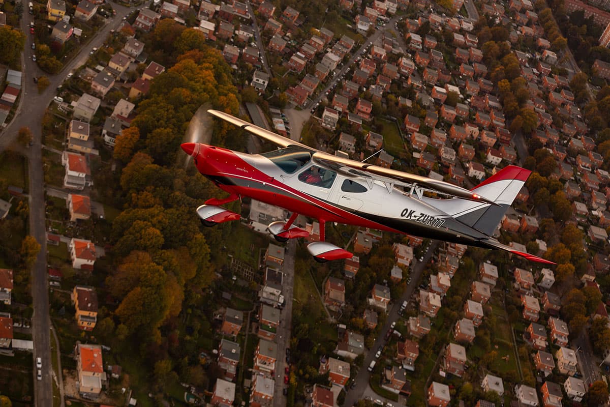 Top-down view of the Bristell B8M over a residential area